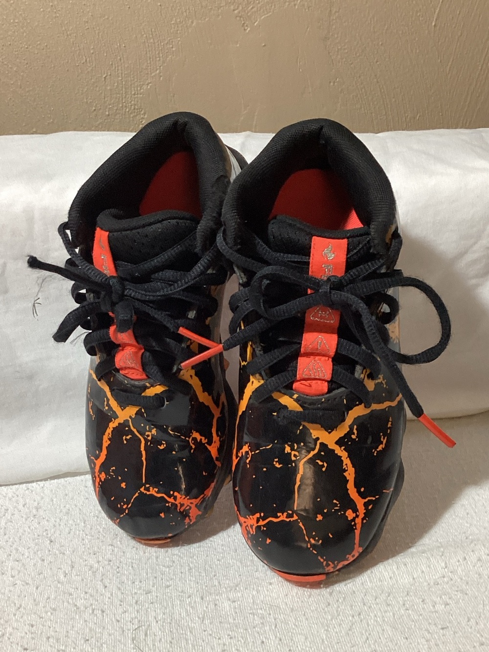 Under Armour Black Cleats with Orange Splash Accents